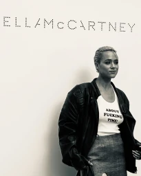 Monochrome portrait of a woman with short blonde hair wearing a black leather jacket and white tank top