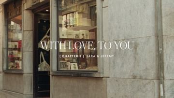 Exterior view of a storefront with greeting cards visible in the window display, as well as text that reads 'WITH LOVE, TO YOU.'
