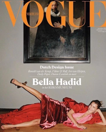 Vogue Nederland cover featuring Bella Hadid lying down in a red dress in front of a framed painting; high-fashion editorial, art and fashion fusion.
