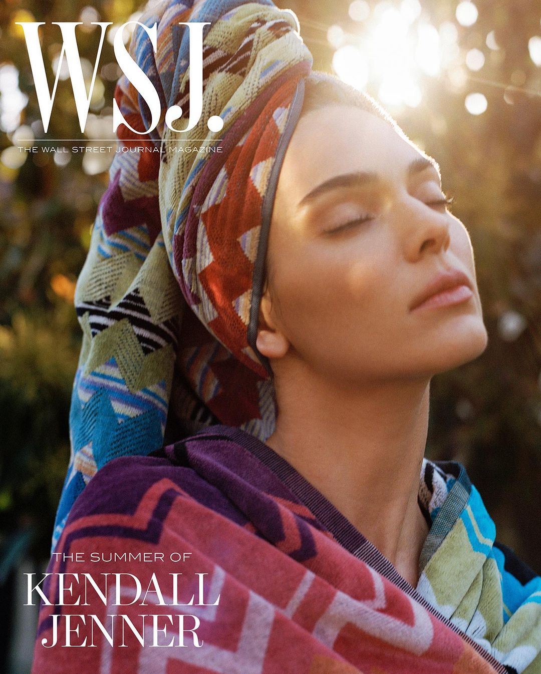 Kendall Jenner cover for WSJ. Magazine, wearing colorful patterned towel, eyes closed, soft natural light, greenery background.