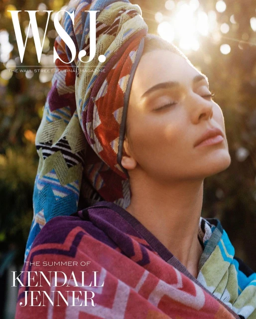 Kendall Jenner cover for WSJ. Magazine, wearing colorful patterned towel, eyes closed, soft natural light, greenery background.
