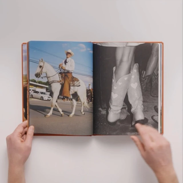 An open book displays a photo of a cowboy on a white horse and a black-and-white shot of cowboy boots, against a white backdrop.