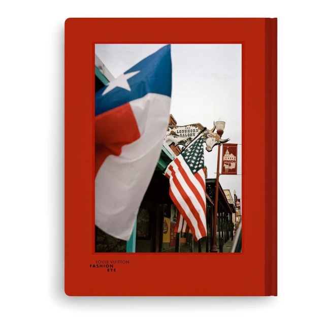 Book cover featuring Texas and USA flags in focus, showcasing Texas pride and American symbolism against a city backdrop.