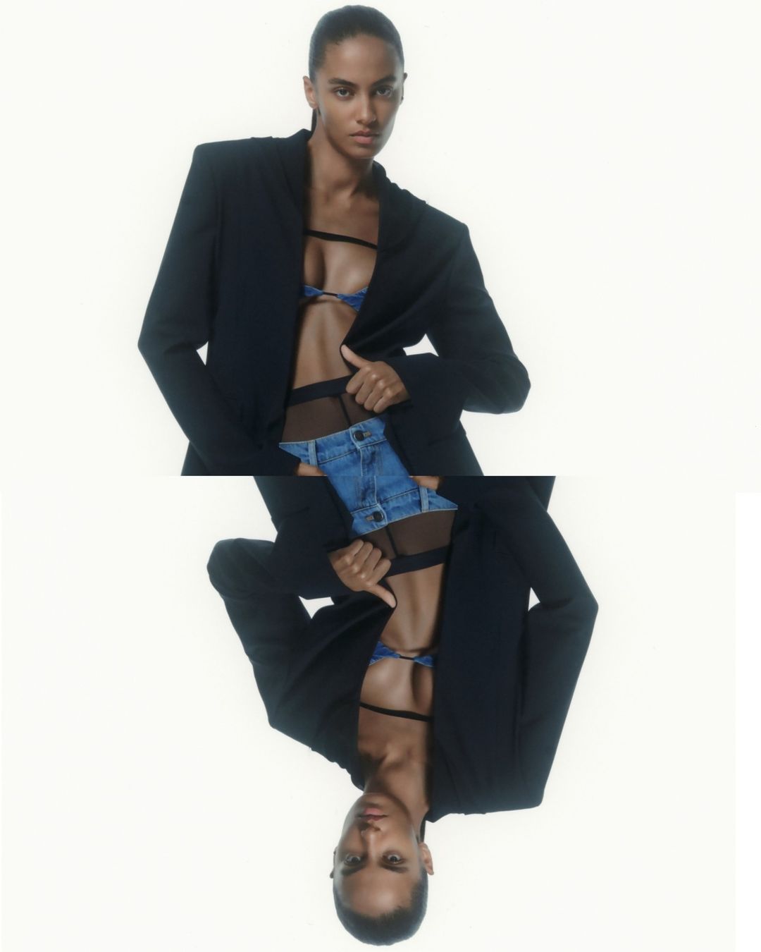 Fashion shot of a Black female model in a black blazer, blue bra, and denim shorts against a white background, mirrored for artistic effect.