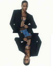 Model wearing a black blazer and denim shorts against a white background, featuring a vertically flipped mirror composition