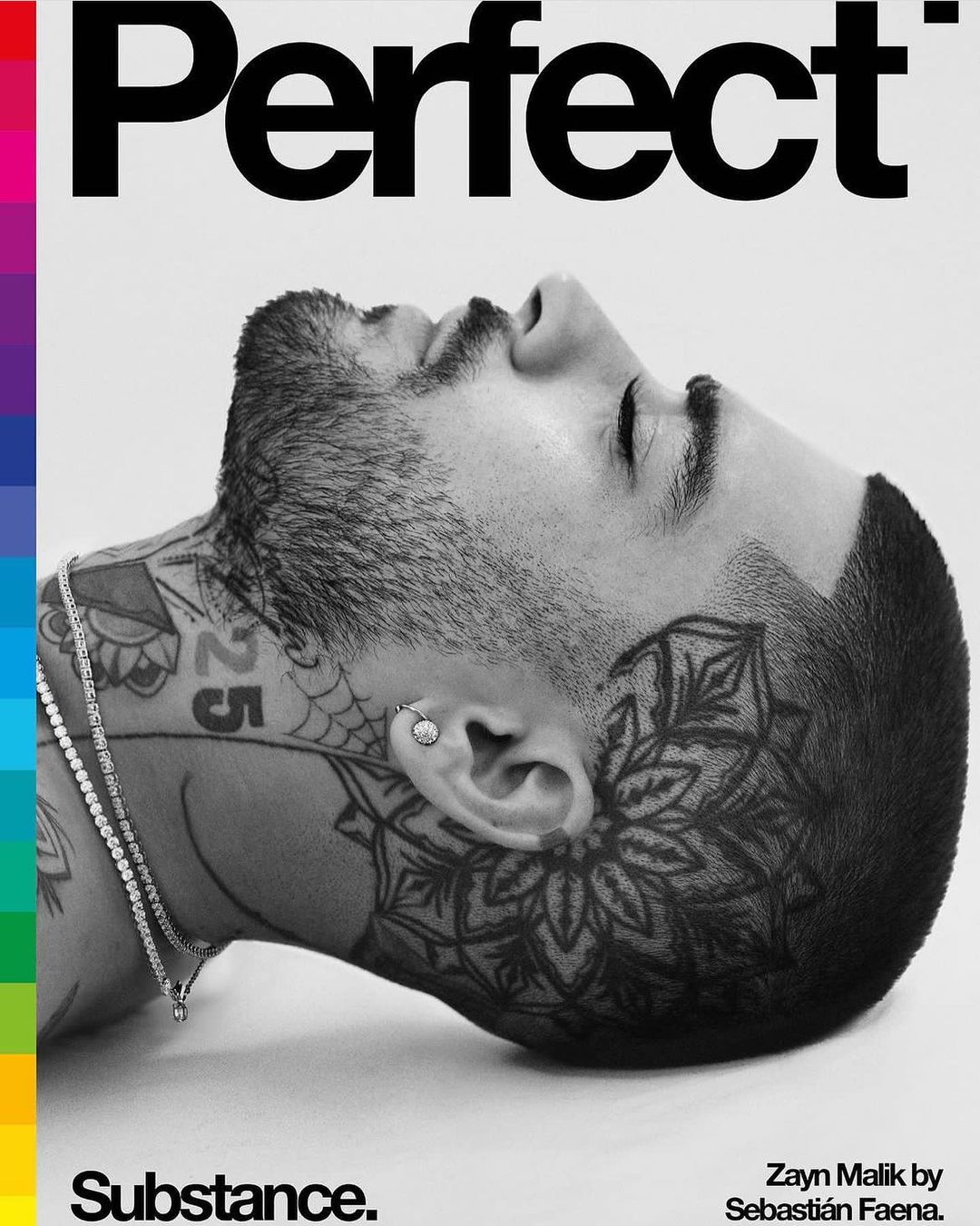 Black and white portrait of Zayn Malik on a magazine cover with colorful stripes, showcasing tattoos and piercing against a white backdrop.