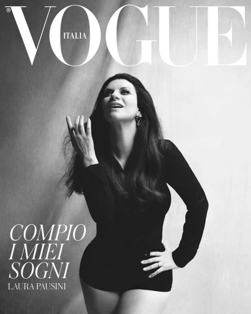 Black and white Vogue Italia cover featuring Laura Pausini in a black top, set against a blurred light gray background, with prominent magazine text.