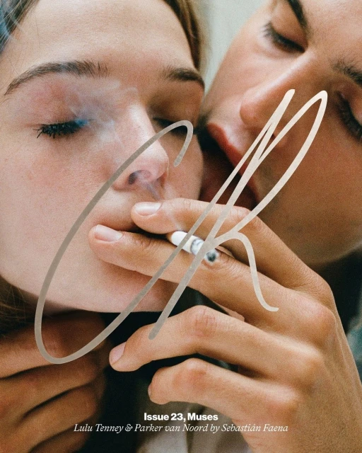 Close up of a couple smoking, soft focus with shallow depth of field, fashion editorial style. One is holding the cigarette and one is leaning in.