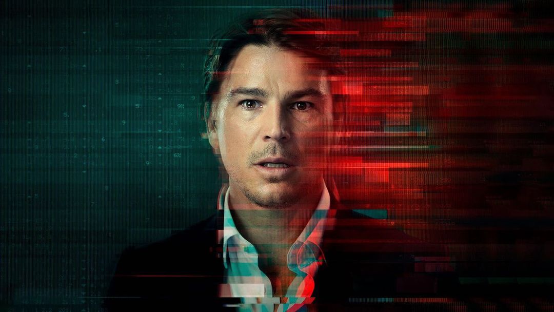 Headshot of a Caucasian adult male in a dark suit and white shirt against a backdrop of teal and red graphic elements.