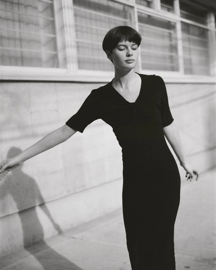 Monochrome portrait of a woman with short dark hair wearing a long black dress outdoors in New York by Sebastian Sabal-bruce
