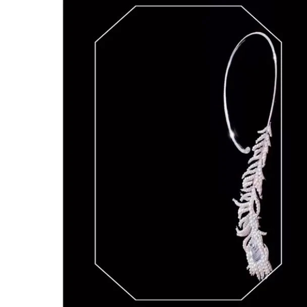 Close-up studio shot of a striking silver choker necklace featuring a feather design adorned with sparkling diamonds against a black background.