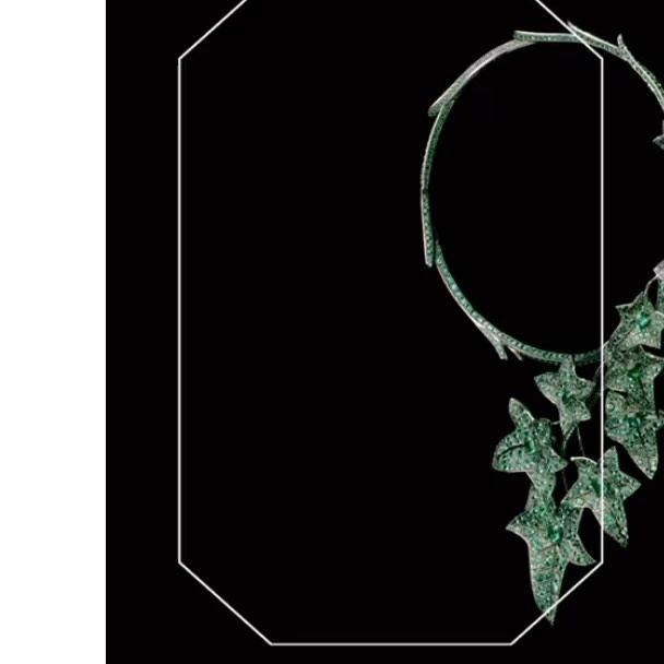 Elegant emerald necklace with leaf-shaped pendants, beautifully displayed against a stark black background, emphasizing luxury jewelry design.