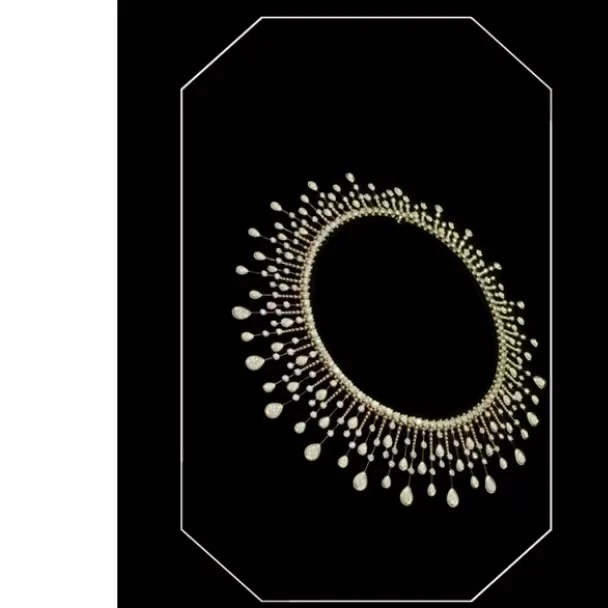 Elegant pearl and crystal beaded necklace jewelry displayed against a solid black background with a modern, minimalist style.