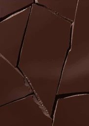 Macro view of broken dark chocolate slabs with sharp fractured edges and deep crevices, captured in Paris.