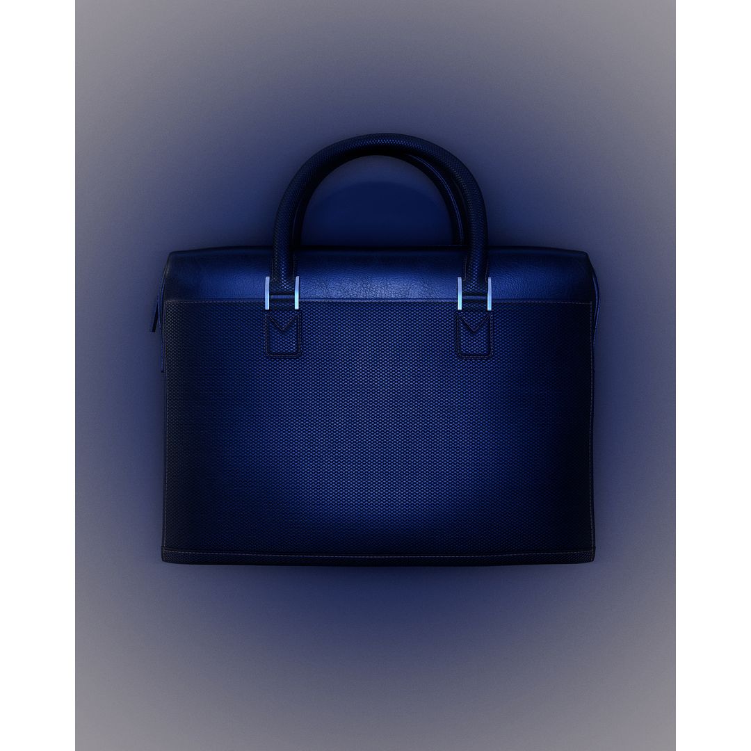 Stylish navy blue textured leather business briefcase with silver metal hardware for carrying documents and technology, presented in studio lighting.