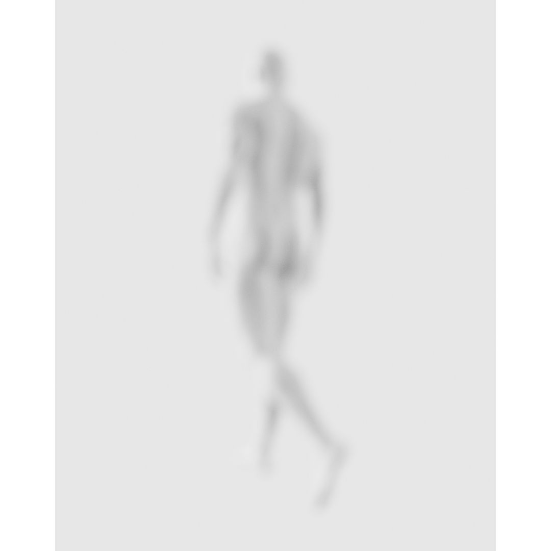 Blurry monochrome photograph of a nude man walking away from the viewer in a neutral indoor space with diffused lighting.