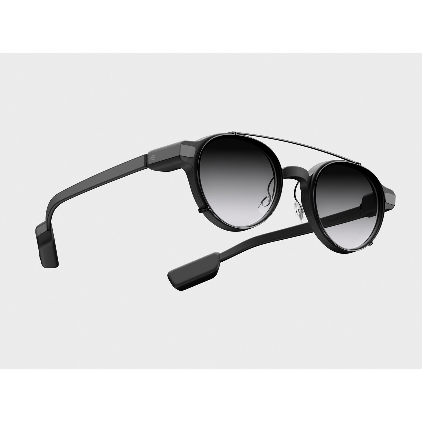 Black sunglasses with round gradient lenses on a white background, showcasing modern eyewear design and optical technology.