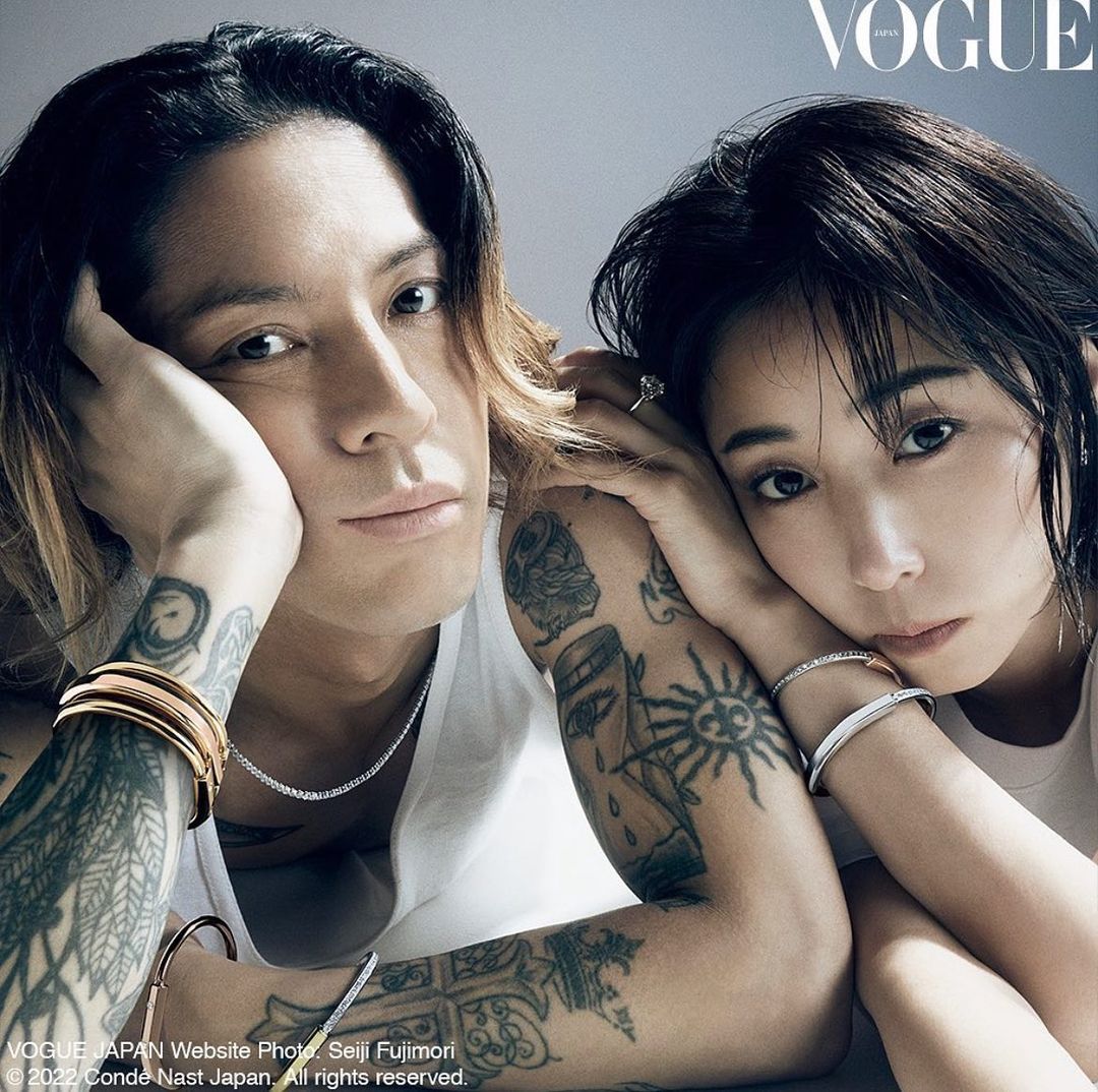 Vogue Japan cover featuring an adult male and adult female model with visible tattoos, silver and gold jewellery, and light skin.