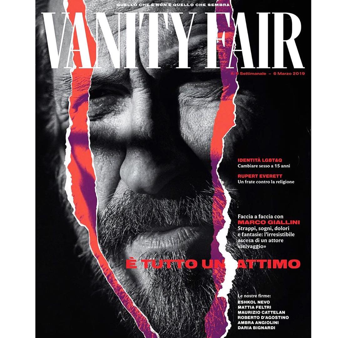 Vanity Fair magazine cover featuring a portrait of an adult male with a beard, overlayed with torn paper and stylized typography.