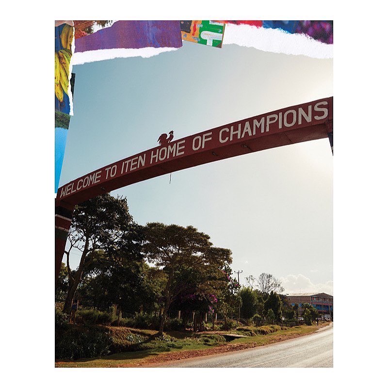 Sign in Iten, Kenya, welcomes visitors to the 'Home of Champions,' framed by trees against a bright sky, showcasing a travel destination.