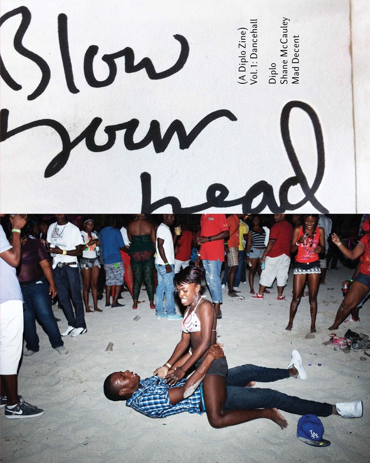 An adult couple on a sandy beach, with a crowd in the background and magazine cover with black text at the top, shot at eye-level.