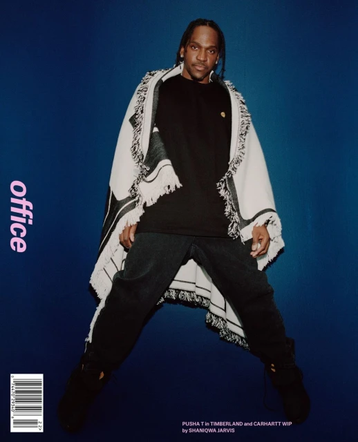 Magazine cover featuring Pusha T in a black t-shirt and draped shawl against a blue gradient background, shot in portrait orientation.
