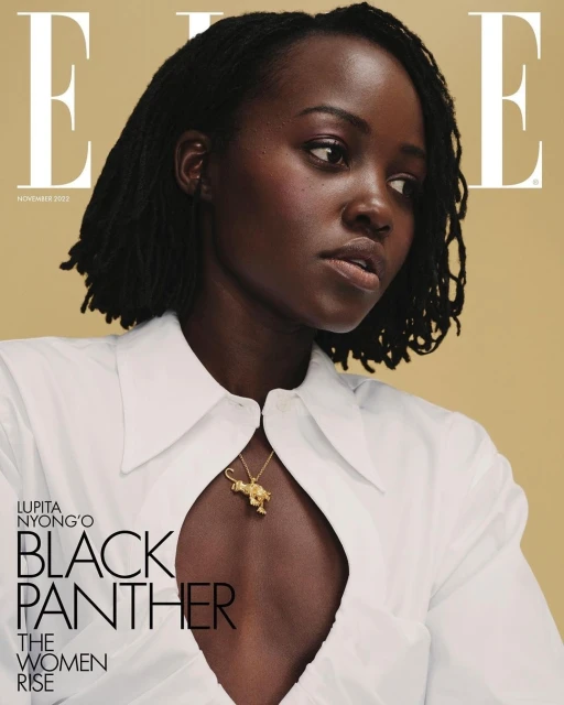 Close-up magazine cover shot of Lupita Nyong'o wearing a white shirt and gold necklace against a tan backdrop with magazine text.