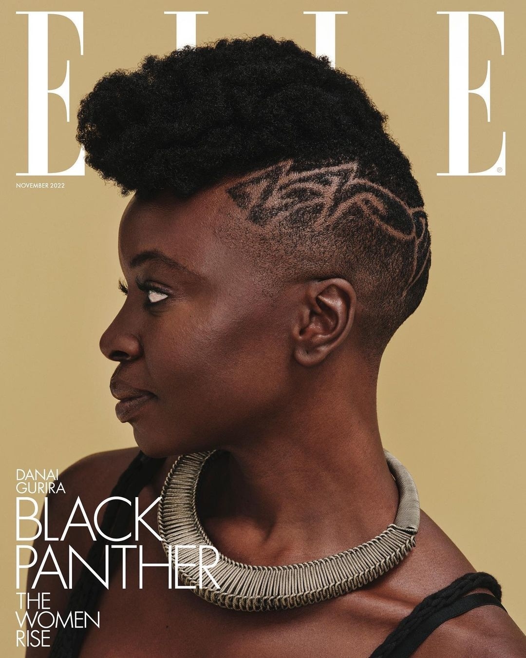 Elle magazine cover featuring Danai Gurira with an afro and statement necklace on a tan background. November 2022 issue.