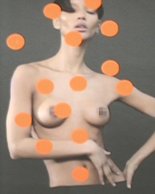 Nude adult female portrait featuring short dark hair, a bare torso, and a neutral expression, partially obscured by bright orange dots.