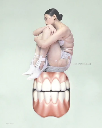 An Asian female model in lingerie and white boots sits atop a large set of teeth in a surreal fashion shot with mint green background.