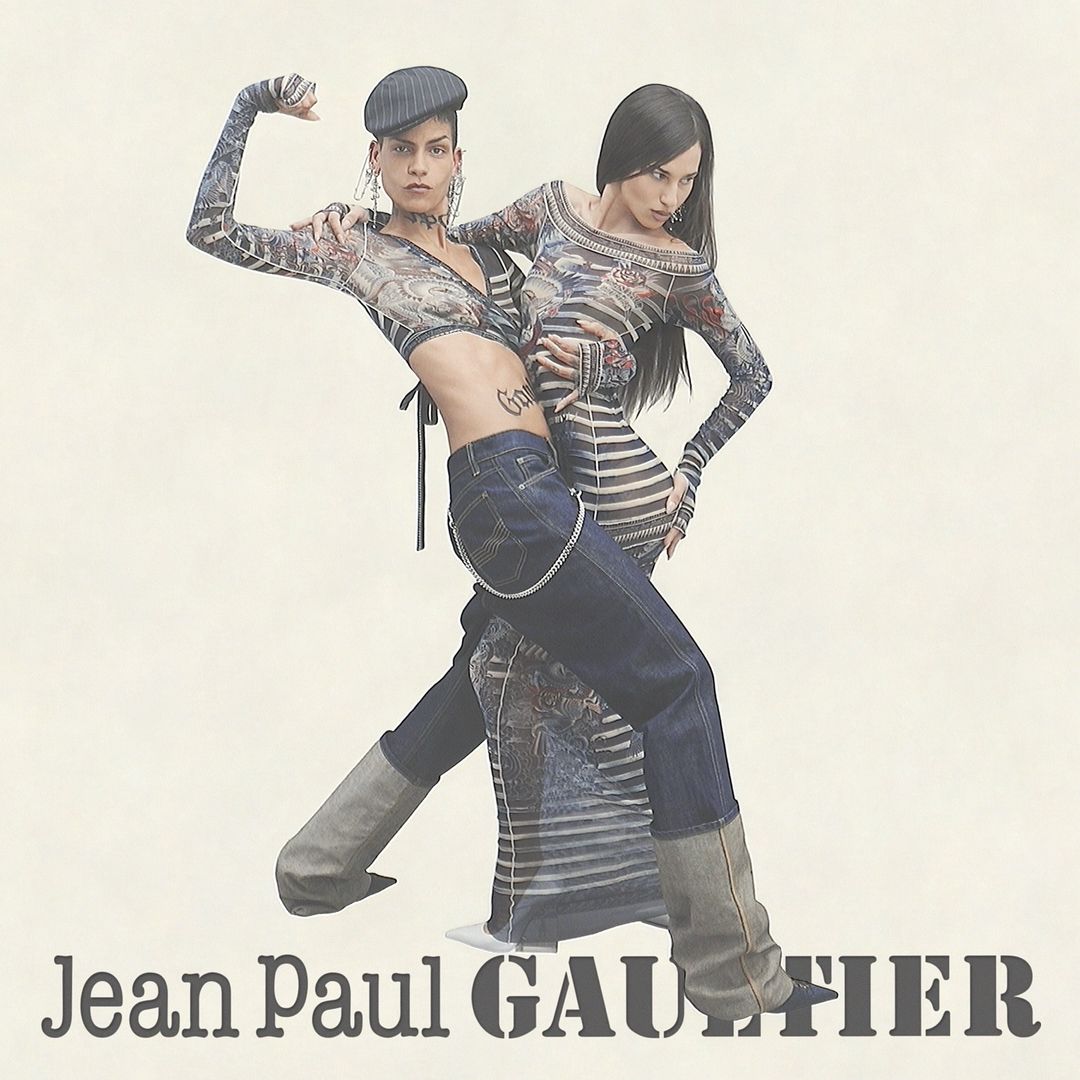 Two adult women pose in matching fashion-forward outfits against a neutral backdrop, showcasing Jean Paul Gaultier apparel and accessories.