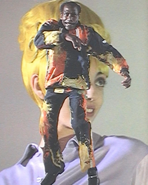 Adult male in bright, paint-splattered clothing strikes a dance pose in front of a woman with yellow hair. Fashion and dance elements.