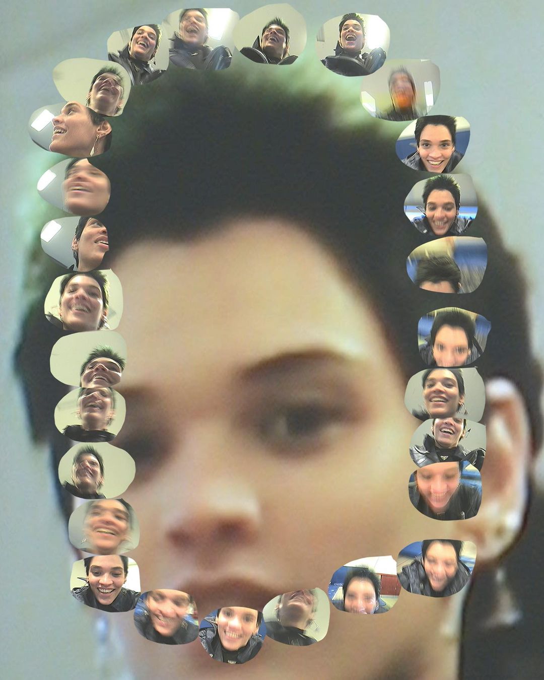 Digitally enhanced image features a large face with digitally-added row of smiling faces resembling a picture frame around the larger face.