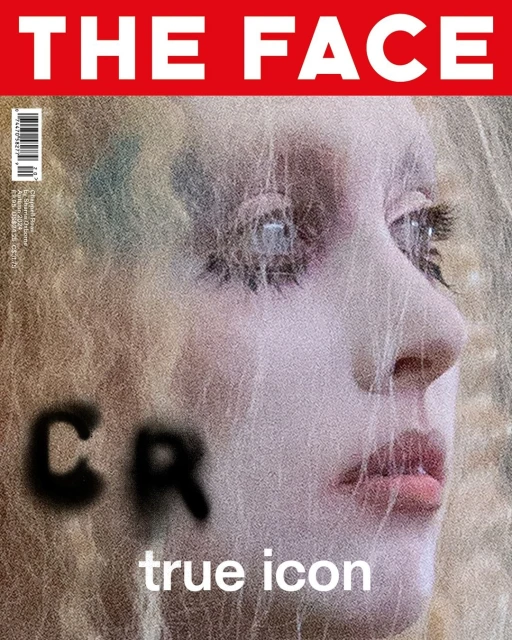 Magazine cover featuring a portrait of a model with blond hair, a close-up perspective, and bold text overlay against a textured background.