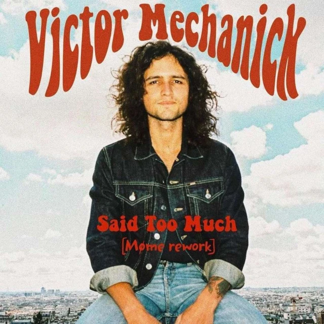 Victor Mechanick album cover featuring the artist in a denim jacket, against a backdrop of a clear sky and city skyline.