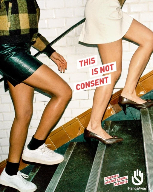 Two women walk up tiled stairs, one in a leather skirt and the other in a white skirt, promoting consent awareness with overlaid text.