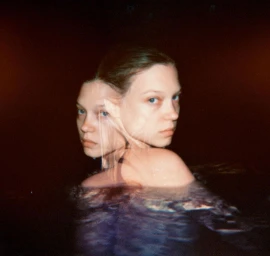 Multiple exposure portrait of a woman in dark water by photographer Shelby Duncan