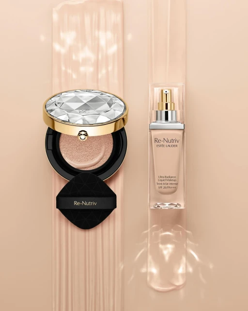Luxury Re-Nutriv Estee Lauder foundation products in a light-beige color palette, including a cushion compact and liquid makeup.