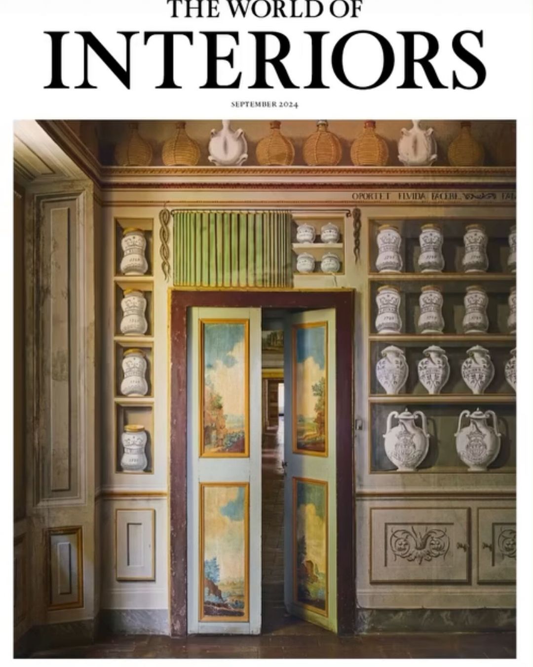Interior shot featuring a magazine cover of 'The World of Interiors' September 2024, with antique cabinet and painted double doors.