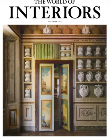 Interior shot featuring a magazine cover of 'The World of Interiors' September 2024, with antique cabinet and painted double doors.