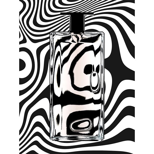 A clear perfume bottle with a black cap reflects a black and white swirling background pattern for an abstract beauty product shot.
