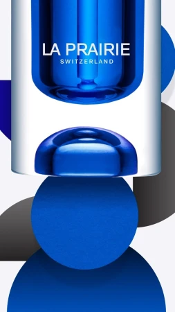 Product shot of La Prairie skincare product with blue and white packaging and geometric circular designs on a white background.