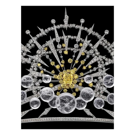 Elaborate diamond tiara featuring white and yellow diamonds in a radial starburst design, set against a stark black background.