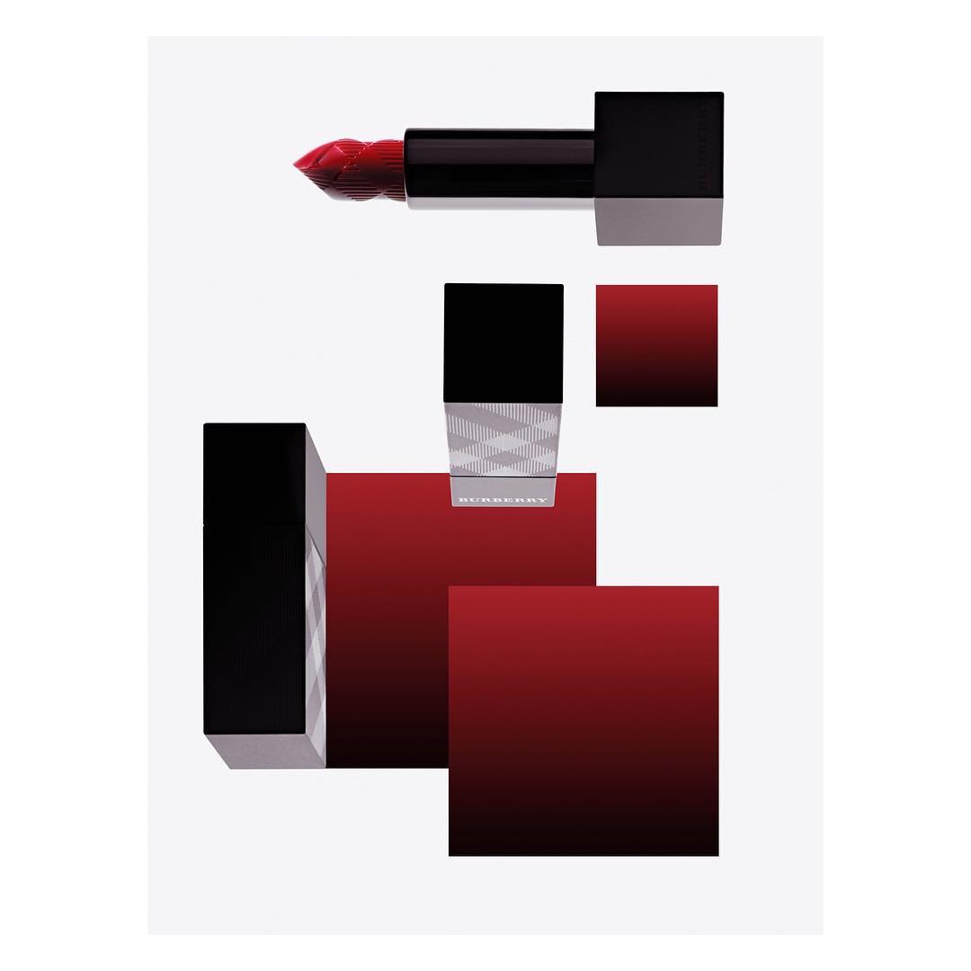 Still life studio shot of Burberry lipstick in black packaging with red shades. Beauty and fashion content with makeup and cosmetics.