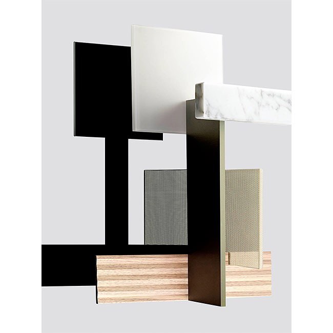 Abstract composition of geometric shapes and textures including wood grain, marble, and black and white panels, studio setting.