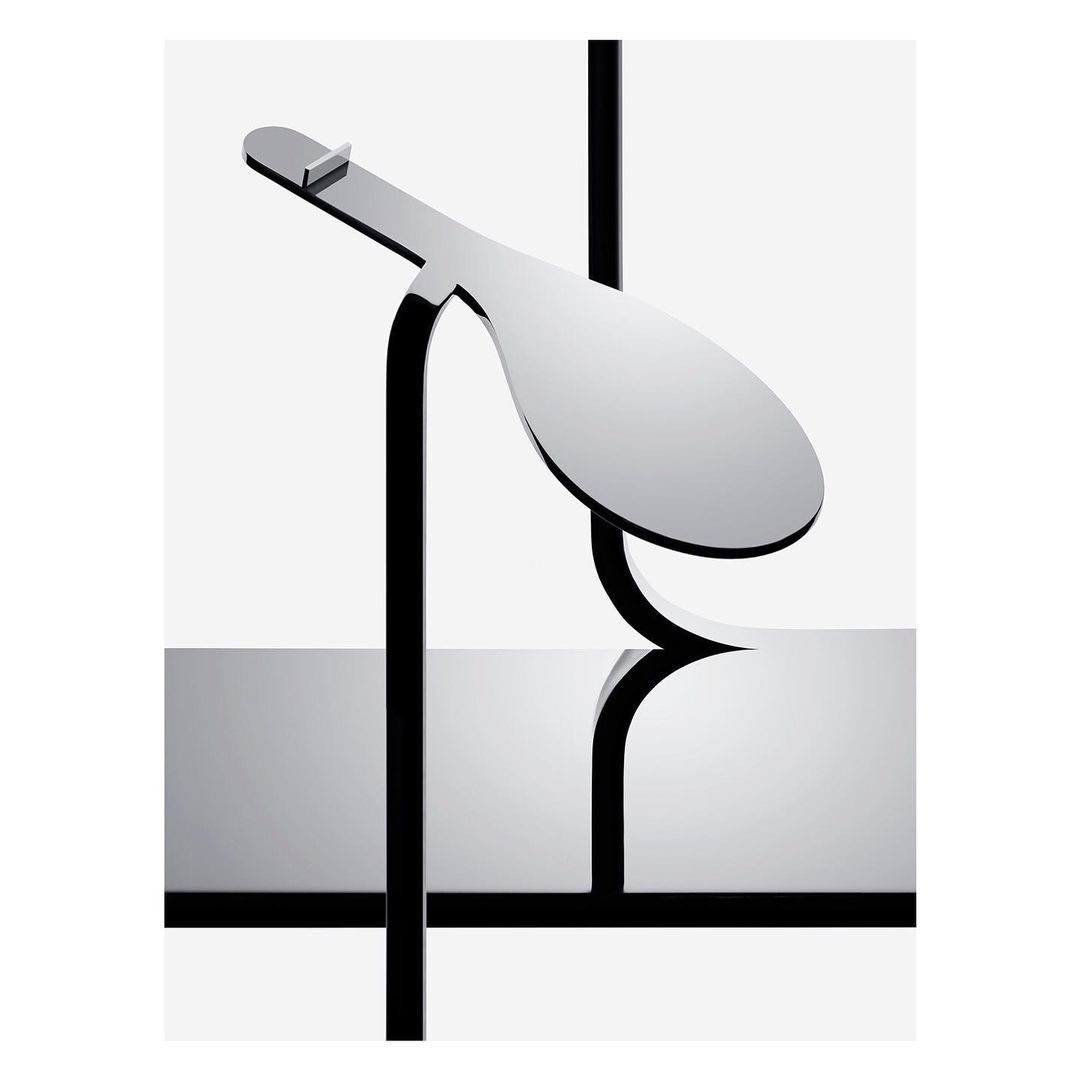 Abstract geometric sculpture featuring a glossy paddle-like form supported by black beams, set against a bright white backdrop.