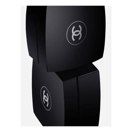 Two stacked black cosmetic boxes with silver logos on a plain white backdrop, minimalist presentation, beauty and luxury concept.