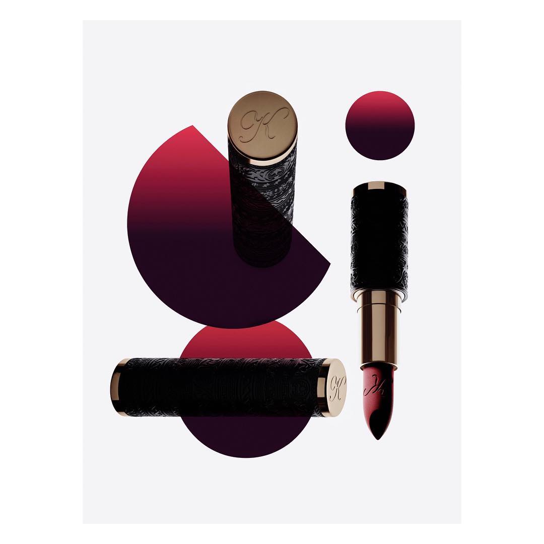 Elegant lipstick tubes in black and gold with geometric red accents on a clean white backdrop, beauty product, studio shot.