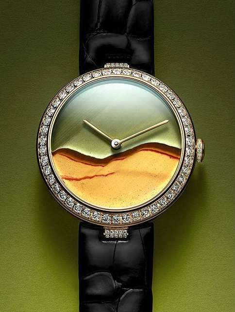 Elegant wristwatch with diamond-studded bezel and black leather band, set against a muted green background. Timeless design meets luxury.