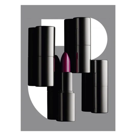 Close-up product photography of black lipstick tubes with one open tube showing purple lipstick, set against a grey graphic background.